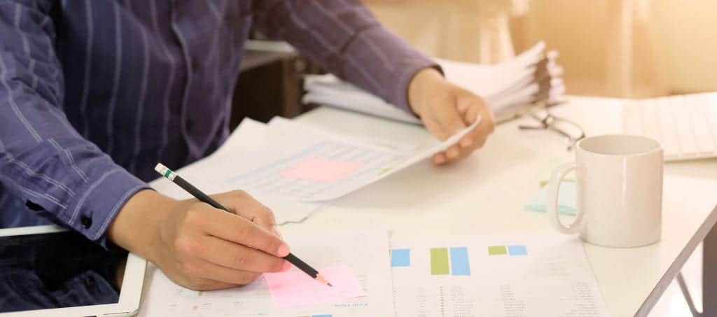 A CPA sitting at a desk with financial forms in front of him